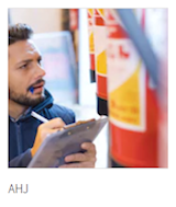 AHJ – inspector examining a fire extinguisher and standpipe cabinet