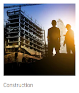 Construction – silhouetted workers at a building under construction